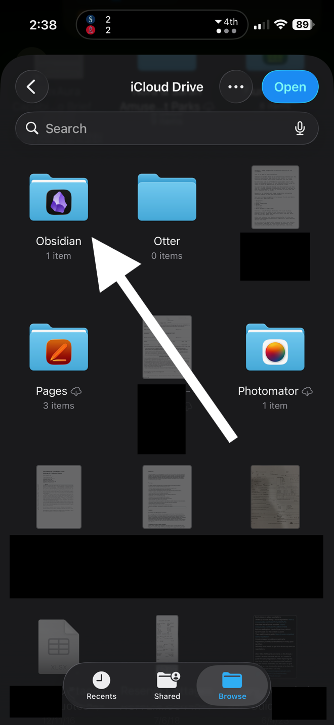iCloud Drive folder picker showing the Obsidian folder highlighted, with an Open button in the top right and a white arrow pointing to the Obsidian folder.